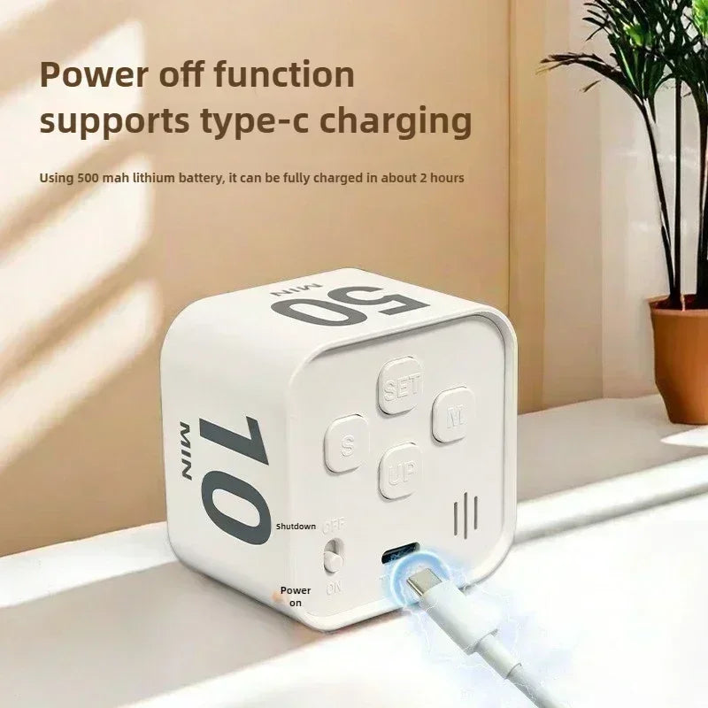 A white productivity cube timer with a gravity sensor is shown next to a USB charging cable.