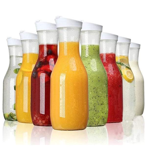 A row of colorful fruit and vegetable smoothies in clear plastic bottles with flip lids