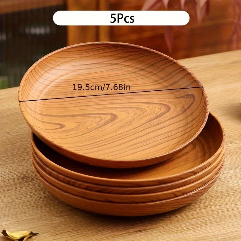 A stack of five round wooden serving trays with a natural wood grain finish.