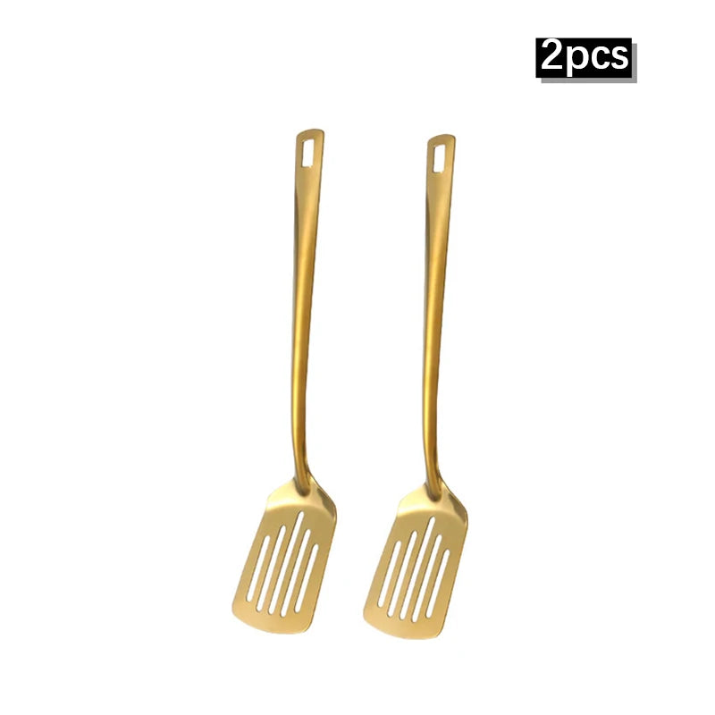 A set of two golden stainless steel soup spoons and colanders.