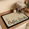 A black mat with a beige woven surface featuring the text Coffee Bar brewed fresh daily self serve.