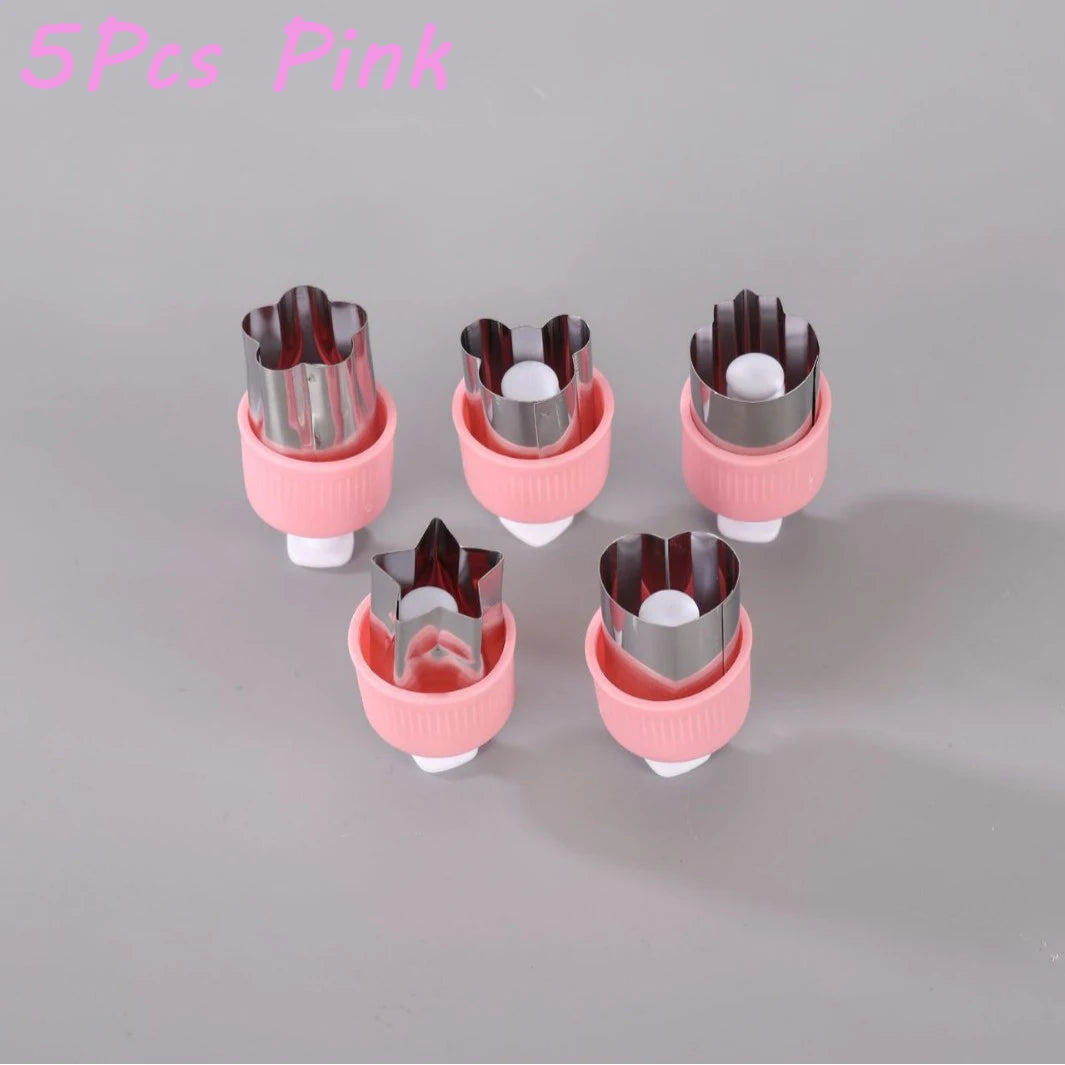 A set of five pink cutting molds for pressing fruit and vegetables.