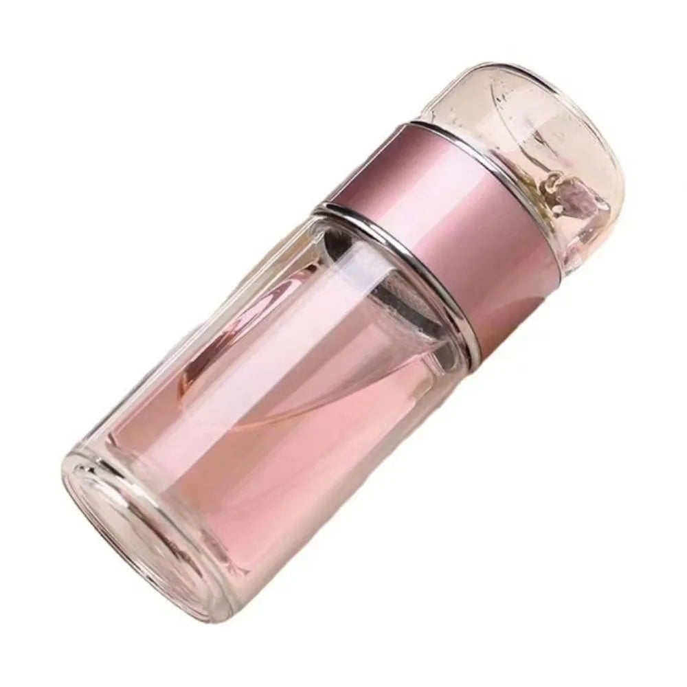 A pink borosilicate glass tea infuser with a rounded top and cylindrical body.
