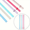 A set of five glitter reusable plastic straws in various colors including pink, blue, and clear.