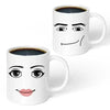 A white ceramic coffee mug featuring a simple, smiling face design.