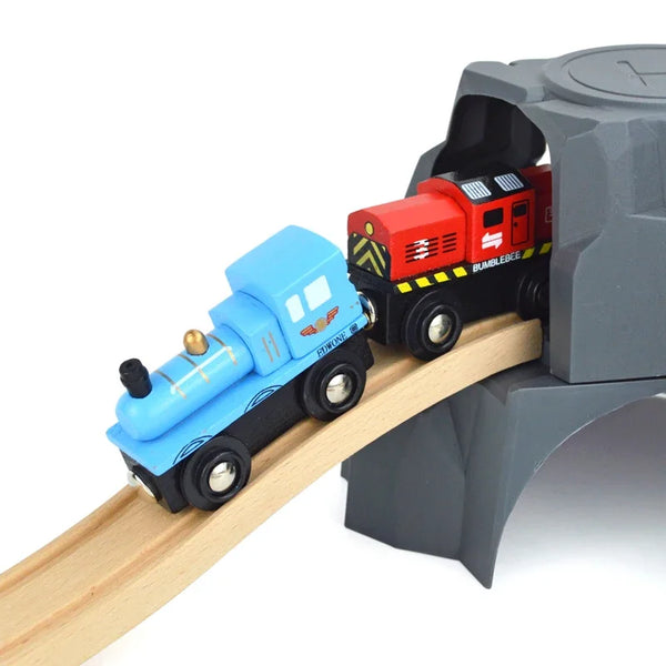 A blue train car and a red train car are placed on a wooden track within a gray magnetic train set.