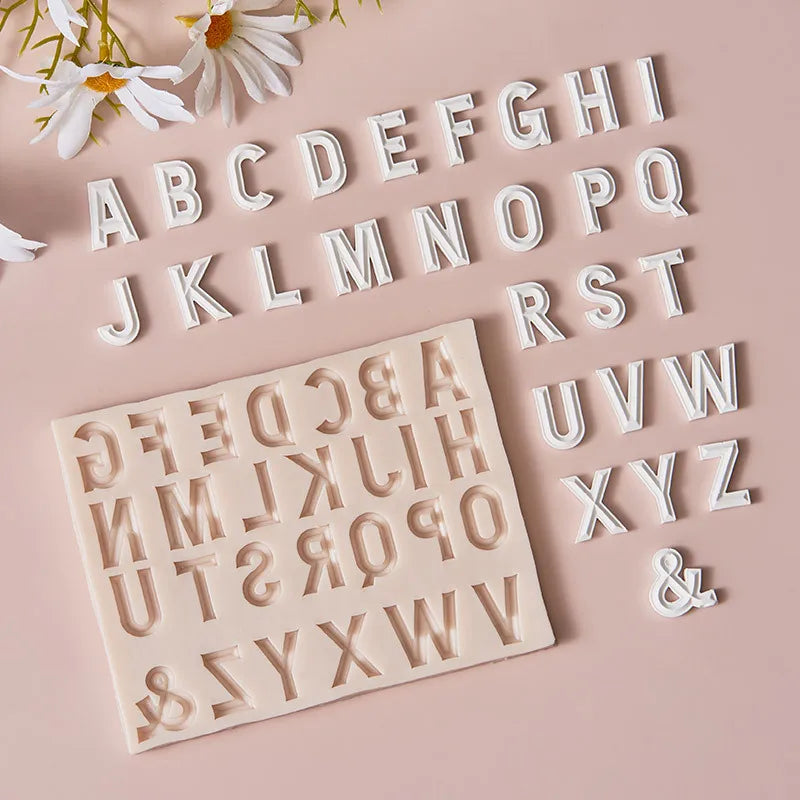 A collection of white silicone alphabet cake decoration molds featuring uppercase and lowercase letters.