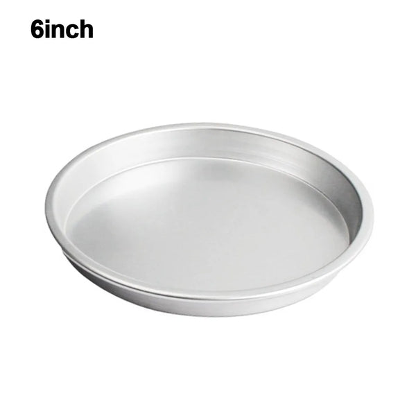 A round, silver non-stick pizza baking pan with a perforated bottom.