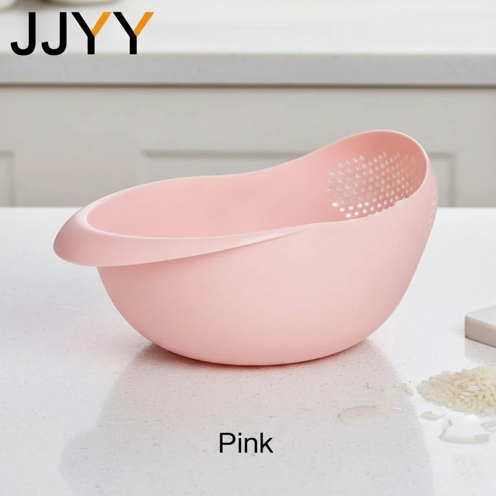 A pink multi-use kitchen drainer colander set with a perforated design sitting on a white surface.