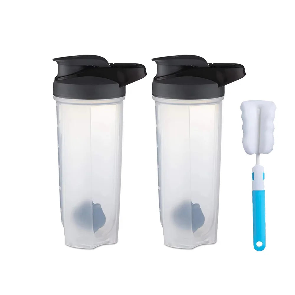 Two clear plastic protein shaker bottles with black lids and a white blender whisk.