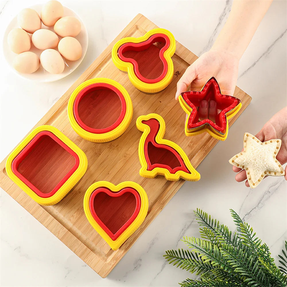 A set of colorful geometric sandwich cutters and sealers arranged on a wooden cutting board.