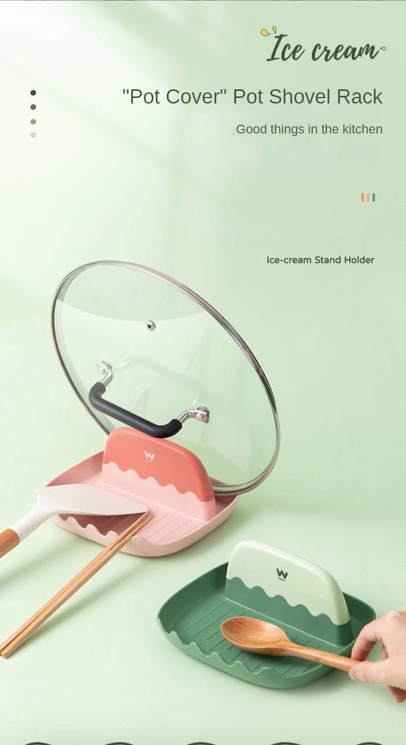 A clear lid cover stand holder for ice cream with a pink spatula rest and wooden utensils.