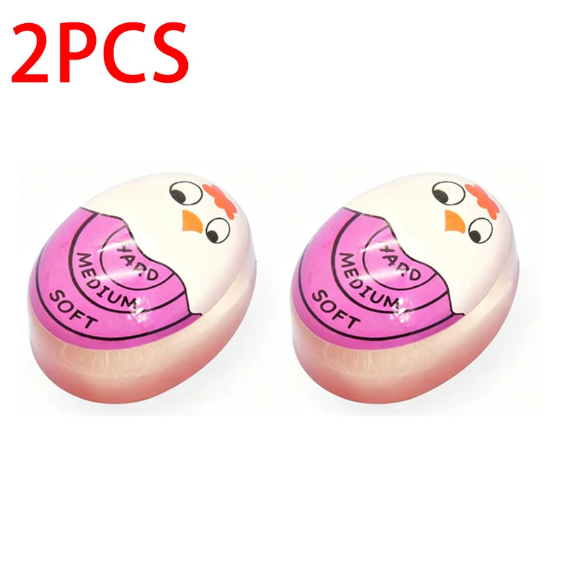 Two pink and white egg cooking timers labeled medium and soft