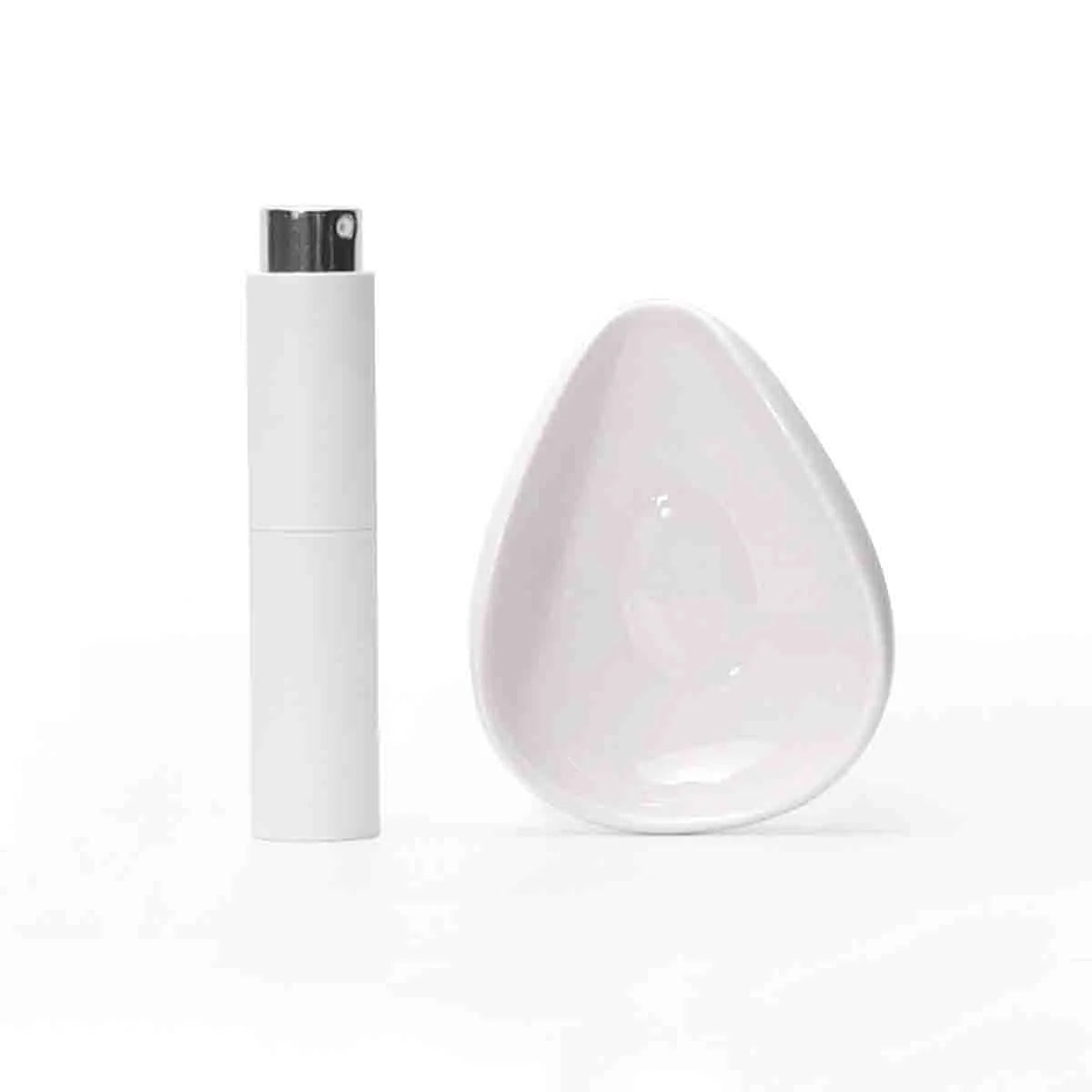 A white ceramic coffee dosing and spray kit with a lid and a white ceramic dish.