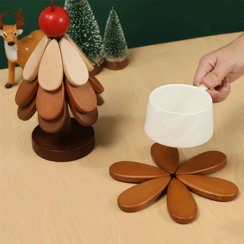 A natural wood foldable trivet with a ceramic cup resting on its petals.