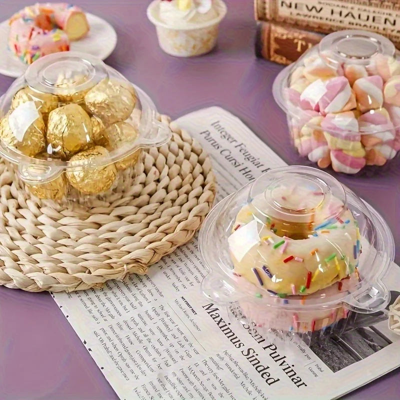 A clear plastic container filled with pink and white decorative items, set next to a woven mat and a book.