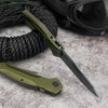 A folding pocket knife with a green handle and D2 blade is shown next to a black cord and sunglasses.
