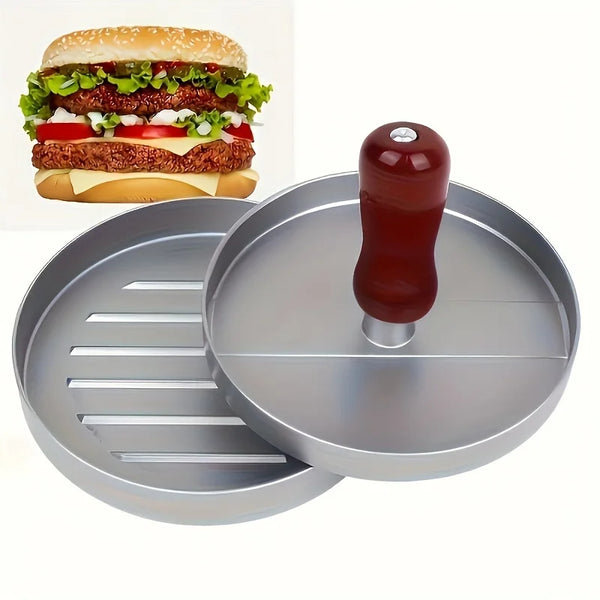 A manual meat patty press tool is shown next to a fully assembled hamburger and a metal grilling plate.