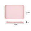 A pink rectangular serving tray with dimensions 24cm by 34cm and a 2cm depth.