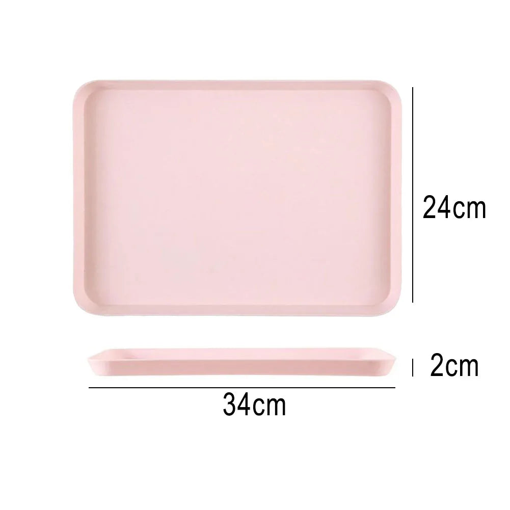 A pink rectangular serving tray with dimensions 24cm by 34cm and a 2cm depth.