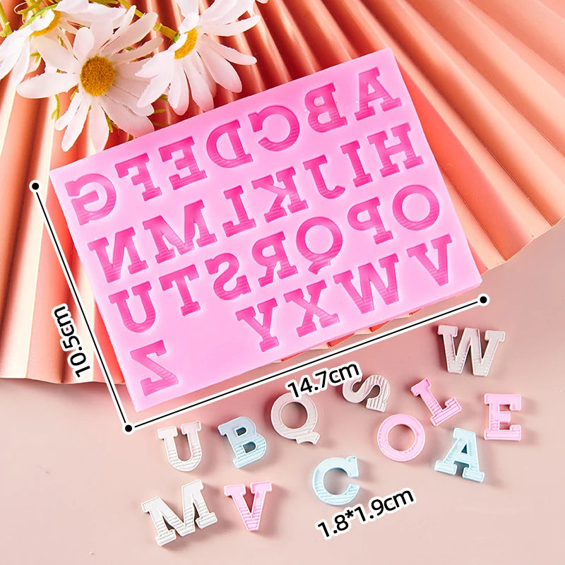 Pink silicone alphabet cake decoration molds with various letters like A B C D E F G H I J K L M N O P Q R S T U V W X Y Z