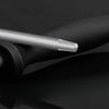 A close-up view of a silver stainless steel knife sharpening rod resting on a black surface.