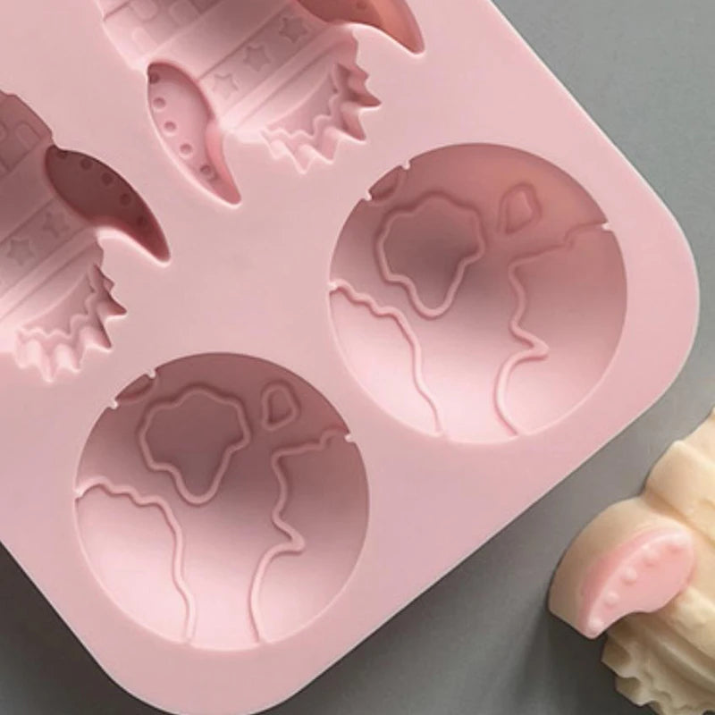 Pink silicone mold tray with various astronaut rocket shapes for DIY crafts