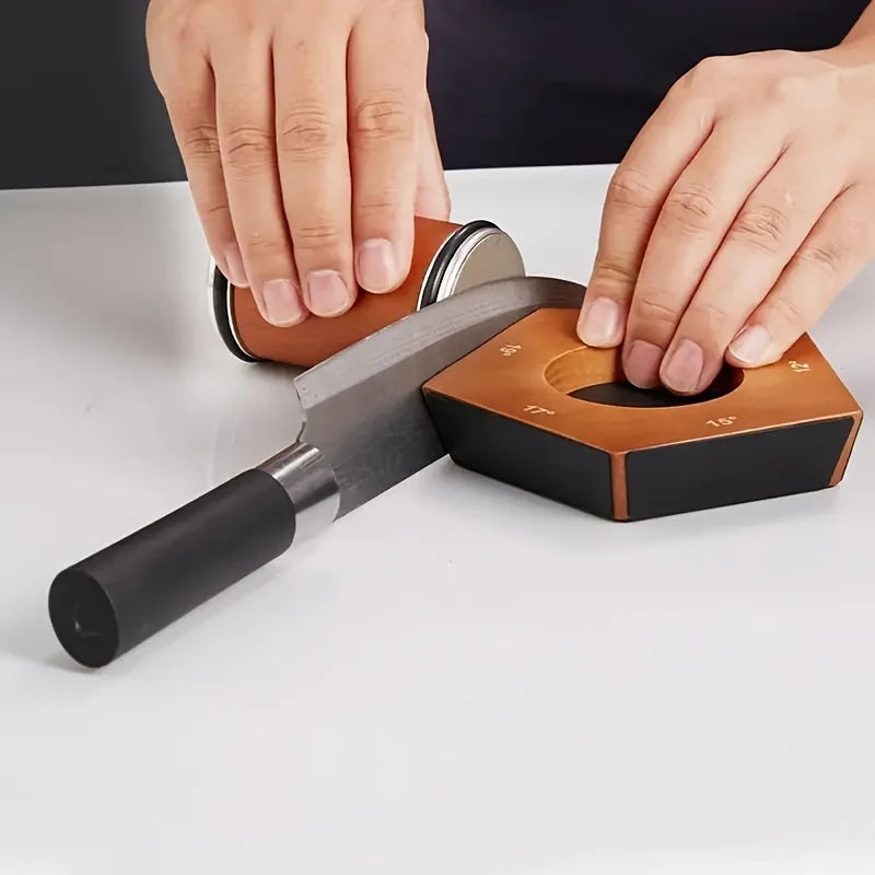 Hands are using a multi-angle rolling knife sharpener to sharpen a blade.