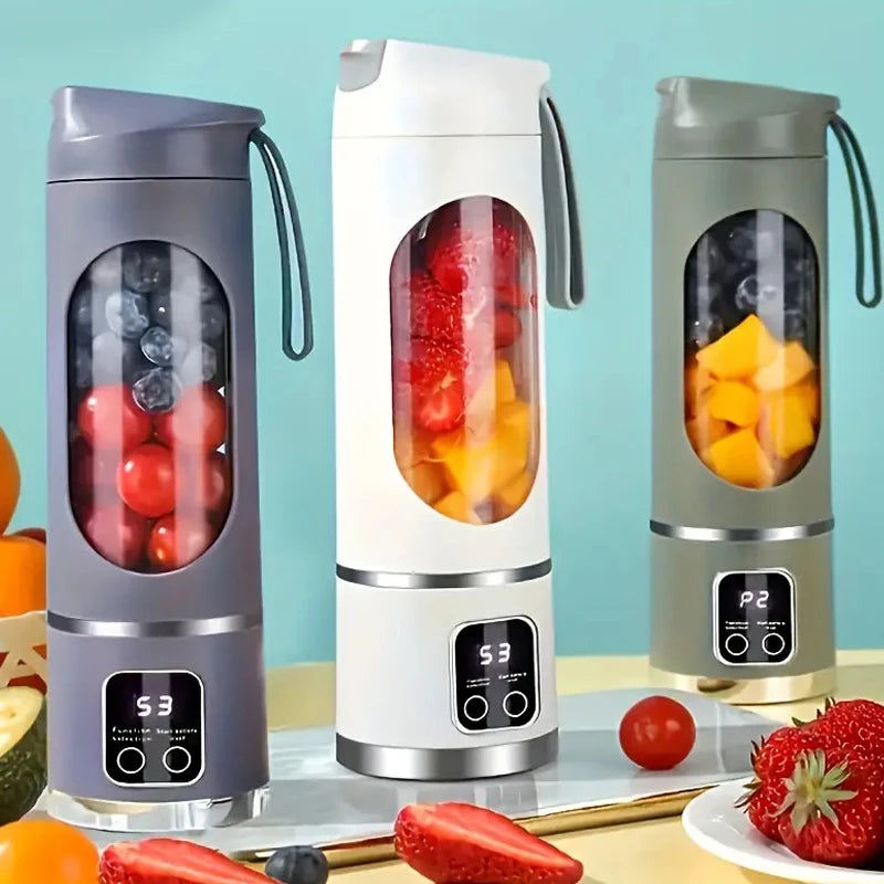 A set of three portable handheld juicers or blenders in gray and white colors displayed on a light surface.