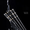 A set of five pairs of non-slip metal chopsticks shown dipping into water, emphasizing easy cleaning and mold proof features.