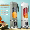 A portable handheld juicer blender in silver and white is shown next to fresh fruit on a wooden surface.