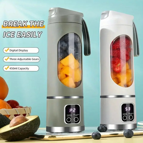 A portable handheld juicer blender in silver and white is shown next to fresh fruit on a wooden surface.