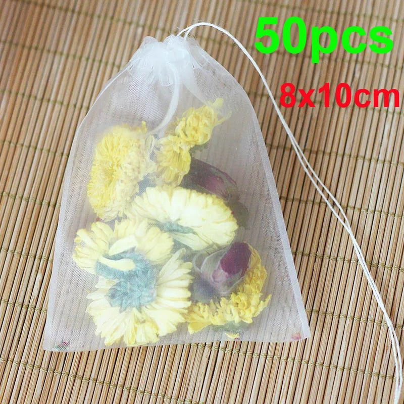A clear mesh bag containing dried yellow and purple flowers used as a disposable tea filter.