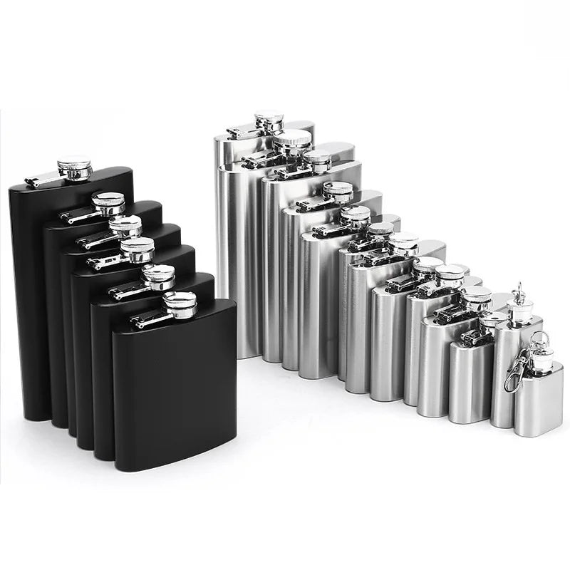 A row of portable stainless steel hip flasks with silver caps displayed on a black surface.