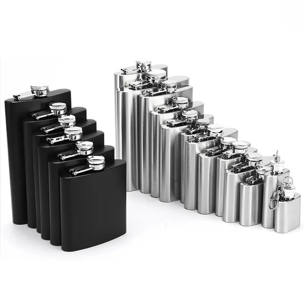 A row of portable stainless steel hip flasks with silver caps displayed on a black surface.