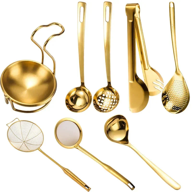 A set of golden stainless steel hot pot colanders and spoons.