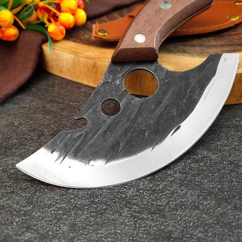 A hand-forged stainless steel meat cutting knife with a wooden handle resting on a dark surface.