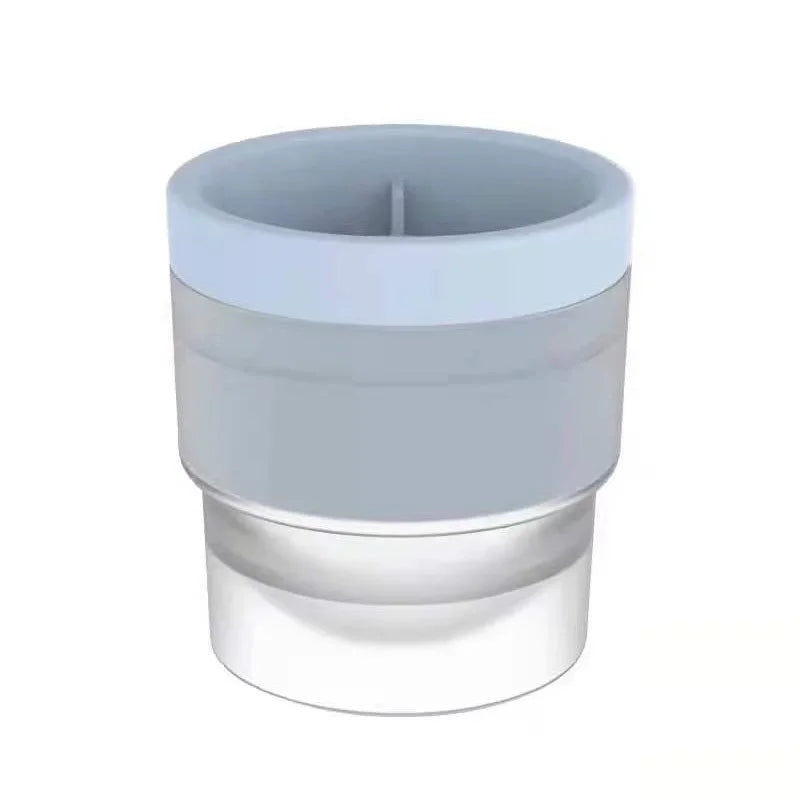 A stackable food-grade ice mold with a clear base and a light blue top, designed for cocktails.