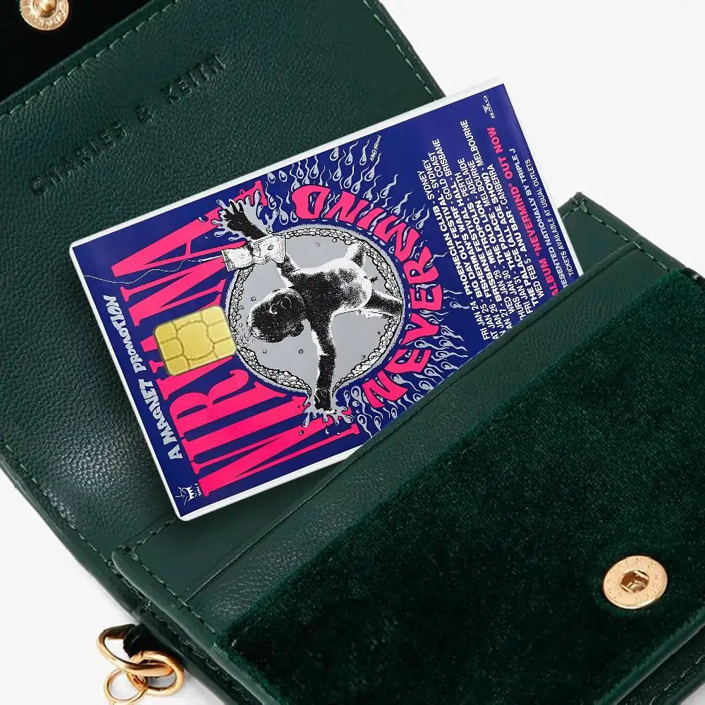 A green wallet with a pink and purple debit card featuring an anime-style Nirvana band design.