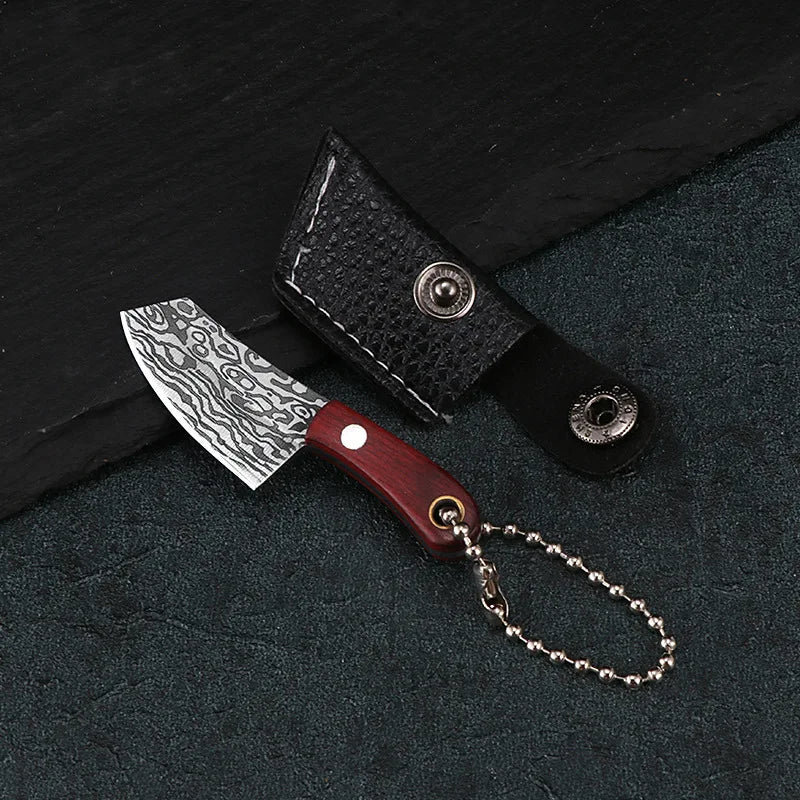 A set of pocket mini knives featuring a Damascus pattern blade, a dark leather sheath, and a wooden handle.