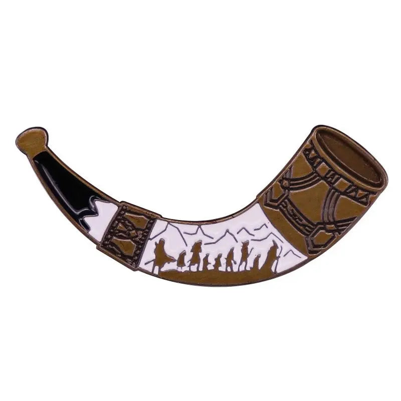 A collectible movie enamel pin and brooch set featuring a brown and white design with silhouettes of people.