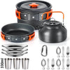 A set of camping cookware including a pot, lid, and various frying pans and cups.