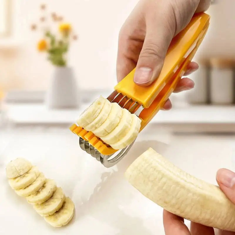 A hand is using an orange manual vegetable slicer to cut a banana, with sliced bananas visible nearby.