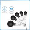 A set of ten stainless steel measuring spoons and a protective shield icon are shown against a white background.