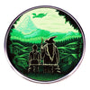 A green enamel pin featuring a wizard figure, a flying creature, and lush green landscape.