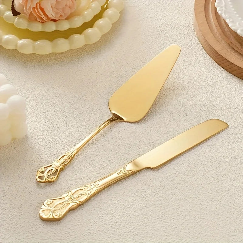 A set of elegant vintage stainless steel bread knife and cake spatula with gold accents on a light background.