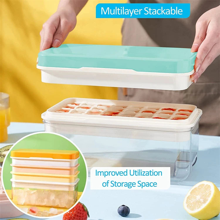 A hand holds a clear silicone ice cube tray set with a storage bin, demonstrating its multilayer stackable design.