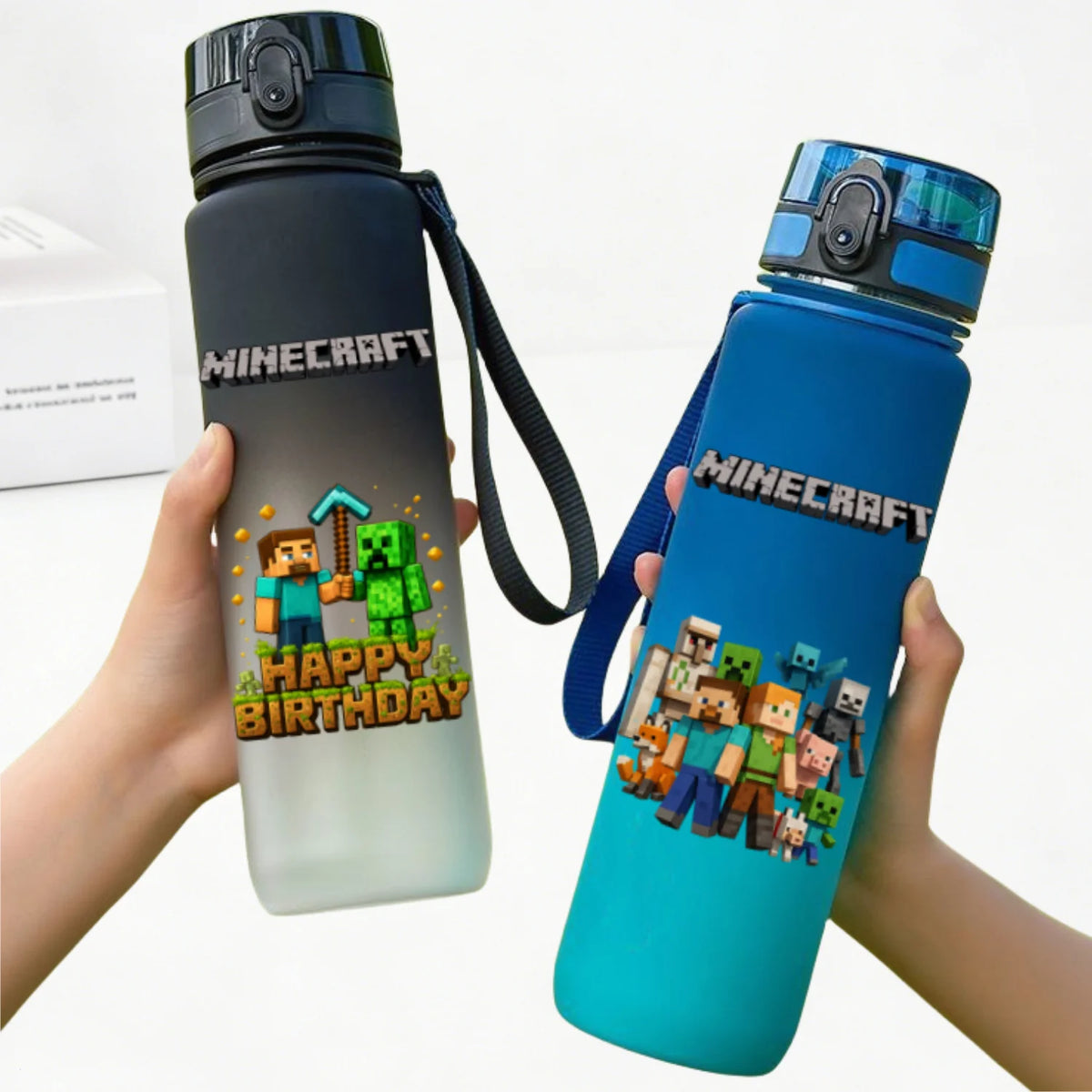 A hand holds a blue Minecraft themed water bottle with a black cap and strap against a white background.