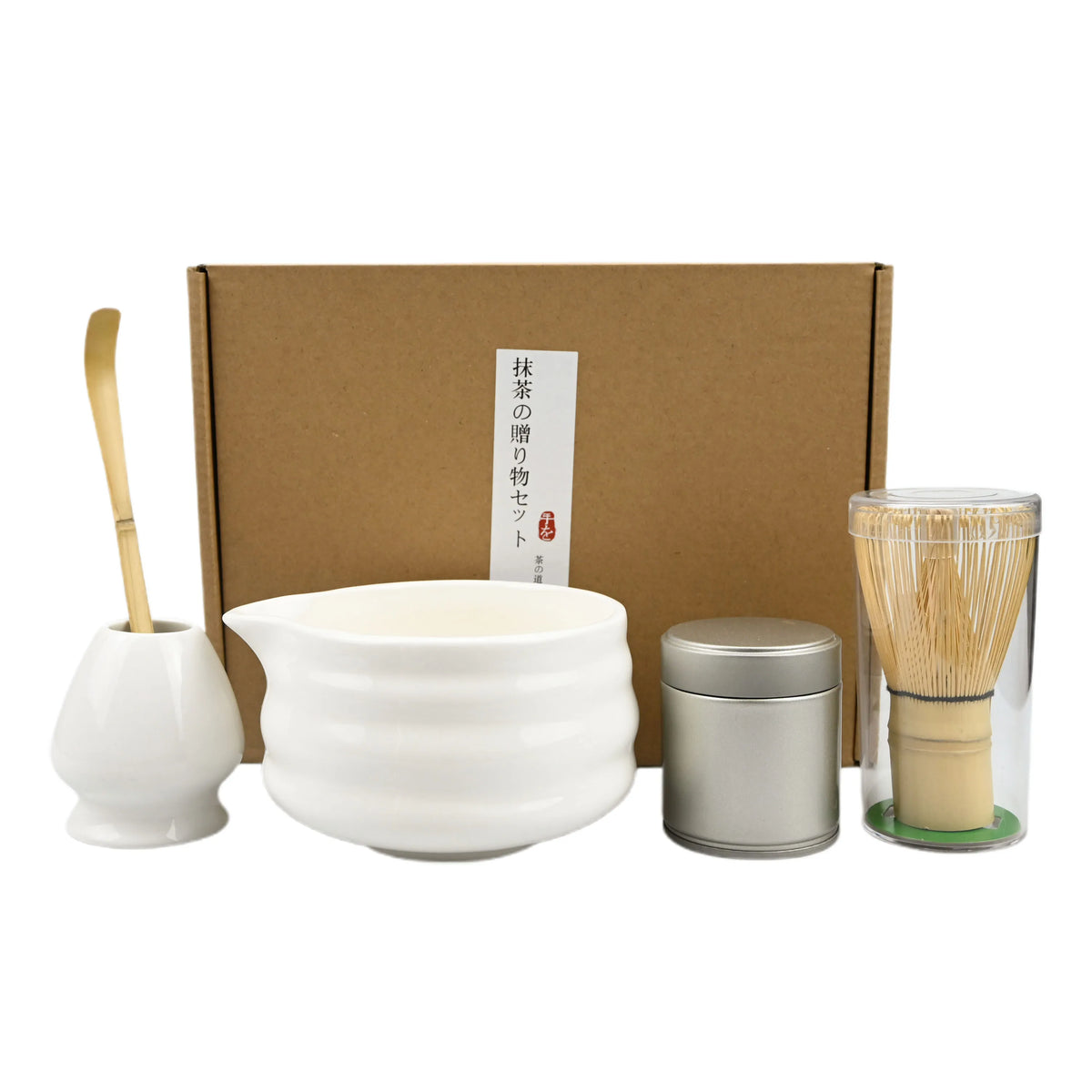 A traditional matcha tea set including a ceramic bowl, whisk, and bamboo brush, packaged in a cardboard box.