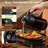 A hand is pouring oil from a black glass dispenser using an easy one-handed spray or pour mechanism.